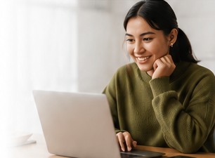 Student attending an online lesson from her laptop
